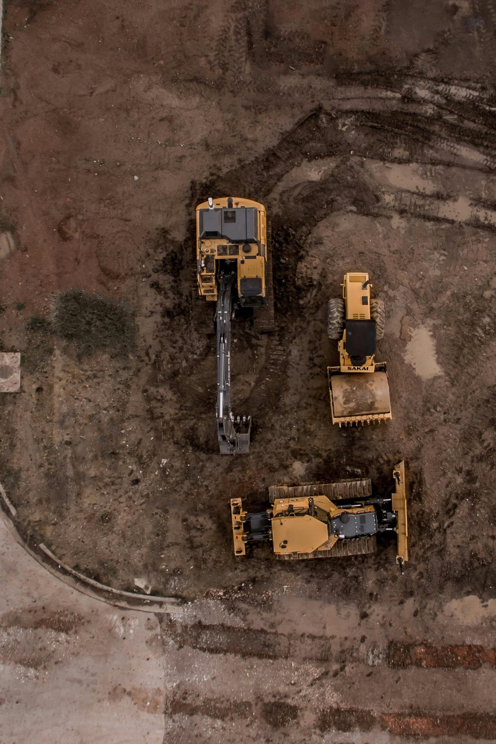 Aerial photo of excavator road roller and bulldozer